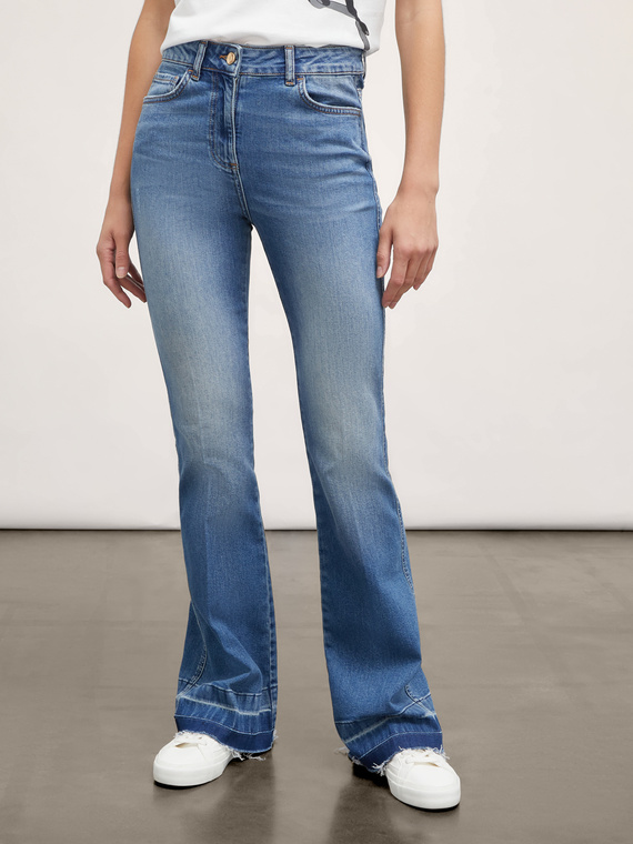 Flared jeans with frayed hem